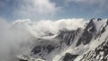 Time lapse of wickedly intense clouds roiling and flowing over peaks