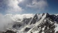 Time lapse of wickedly intense clouds roiling and flowing over peaks
