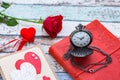 Time for love: red rose, heart, and journal with pocket watch Royalty Free Stock Photo