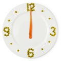 Time of lunch, ÃÂlock from plate, carrots and green peas Royalty Free Stock Photo