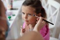 Mother helping her little girl with make up Royalty Free Stock Photo