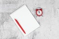 Time management concept. To-do list: red alarm clock, pencil and notebook Royalty Free Stock Photo