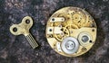 Time management concept, vintage key and gold watch clockwork mechanism, gears, timing