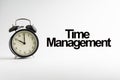 TIME MANAGEMENT inscription written and alarm clock on white background Royalty Free Stock Photo