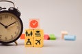 Time management and quality time concept. Wooden blocks with clock, family, education, working and travel symbols