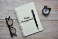 TIME MANAGEMENT text on notebook with pen, spectacles and analog alarm clock. Business concept Royalty Free Stock Photo