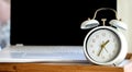 Close-up clock in front of a laptop blurred background Royalty Free Stock Photo