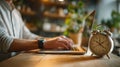 Time Management: Working on Laptop with Alarm Clock on Desk Royalty Free Stock Photo