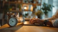 Time Management: Working on Laptop with Alarm Clock on Desk Royalty Free Stock Photo