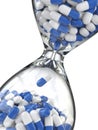 Time of medicine. Pills in hourglass