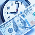 Time is money. Alarmclock with Dollars cash as symbol of business, wealth and work. Royalty Free Stock Photo