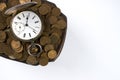Time is money, a bunch of coins with a pocket watch on top Royalty Free Stock Photo