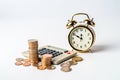 Time is money. Coins with alarm clock and calculator on white background. Concept of financial savings and payments. Royalty Free Stock Photo