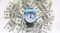 Time - money concept with clock and dollar bills closeup Royalty Free Stock Photo