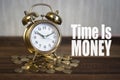 Time is money concept - golden alarm bell clock