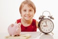 Time is money. Cute little business child girlwith alarm clock and piggy bank Royalty Free Stock Photo