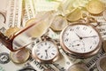 Time is money finance concept with old vintage clocks, dollar bills, euro coins and glasses Royalty Free Stock Photo