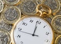 Time and money, a gold watch on top UK pound coins Royalty Free Stock Photo