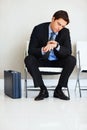 Time is money-Businessman checking the time. Time is money - Portrait of a young businessman checking the time on wrist Royalty Free Stock Photo