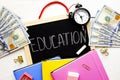 Investing time and money into education concept. Different school supplies, banknotes. Top view, close up. Royalty Free Stock Photo