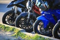 View of motorcycle wheels at the curb on a sunny evening