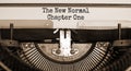 Time for a new normal. Text `The new normal, chapter one` typed on retro typewriter. Business and post-pandemic covid-19 concept