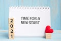 Time for A New Start words and 2021 cubes with red heart shape decoration on blue wooden table background. New Year NewYou, Goal, Royalty Free Stock Photo