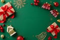 Top view of gifts, baubles, snowflake, and other imaginative Christmas tree toys on green canvas Royalty Free Stock Photo