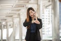 Time out concept. Urgent work, business woman seeing wrist watch and using mobile phone before meeting. Smart woman check the Royalty Free Stock Photo