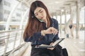 Time out concept. Urgent work, business woman seeing wrist watch and using mobile phone before meeting. Smart woman check the