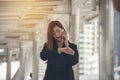 Time out concept.Urgent work,business woman seeing wrist watch and using mobile phone before meeting.Smart woman check the Royalty Free Stock Photo