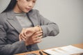 Time out concept. Urgent work, business woman seeing wrist watch and using mobile phone before meeting. Smart woman check the Royalty Free Stock Photo