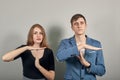 Time out gesture, break, doing t symbol, sign with help of hands. Young couple Royalty Free Stock Photo