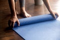 Time for practice, female hands unrolling blue yoga mat Royalty Free Stock Photo