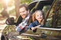 Time is precious. Waste it wisely. Father and daughter looking out the car window and smiling happily at the camera Royalty Free Stock Photo