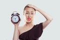 Time pressure. Closeup portrait woman stressed employee holding clock looking at you camera anxiously running out of time isolated Royalty Free Stock Photo