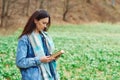 Time for reading. Woman with book over nature background. Reading book concept. Hipster young girl on a walk in spring Royalty Free Stock Photo