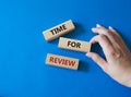 Time for Review symbol. Wooden blocks with words Time for Review. Beautiful blue background. Businessman hand. Business and Time Royalty Free Stock Photo