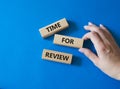 Time for Review symbol. Wooden blocks with words Time for Review. Beautiful blue background. Businessman hand. Business and Time Royalty Free Stock Photo