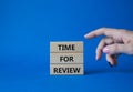 Time for Review symbol. Wooden blocks with words Time for Review. Beautiful blue background. Businessman hand. Business and Time Royalty Free Stock Photo