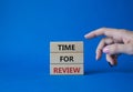 Time for Review symbol. Wooden blocks with words Time for Review. Beautiful blue background. Businessman hand. Business and Time Royalty Free Stock Photo