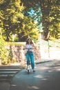 Smiling woman riding scooter in nature