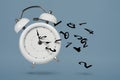 Time is running out. White alarm clock with flying numbers as a symbol of lost time. The concept of time is running out Royalty Free Stock Photo