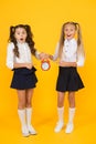 It is time. School schedule. Schoolgirls and alarm clock. Children school pupils. Knowledge day. School time. Surprised Royalty Free Stock Photo