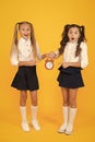 It is time. School schedule. Schoolgirls and alarm clock. Children school pupils. Knowledge day. School time. Surprised Royalty Free Stock Photo