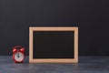 Time for shopping. Black friday. Big sale backdrop. Blank chalkboard and red alarm-clock on dark background, copy space Royalty Free Stock Photo