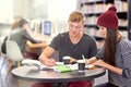Time for some revision. two college students studying together at the library. Royalty Free Stock Photo