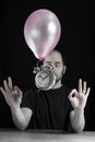 Time stands still concept - picture of a man with his eyes closed in a very zen like mood while an old metal clock levitates Royalty Free Stock Photo