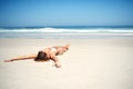 Time for a tan. an attractive young woman lying on the beach in a bikini. Royalty Free Stock Photo