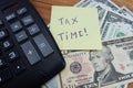 Time taxes, on the table is a calculator and money dollars Royalty Free Stock Photo